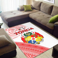Tonga area rug on floor with white field, red border pattern, and crest emblem