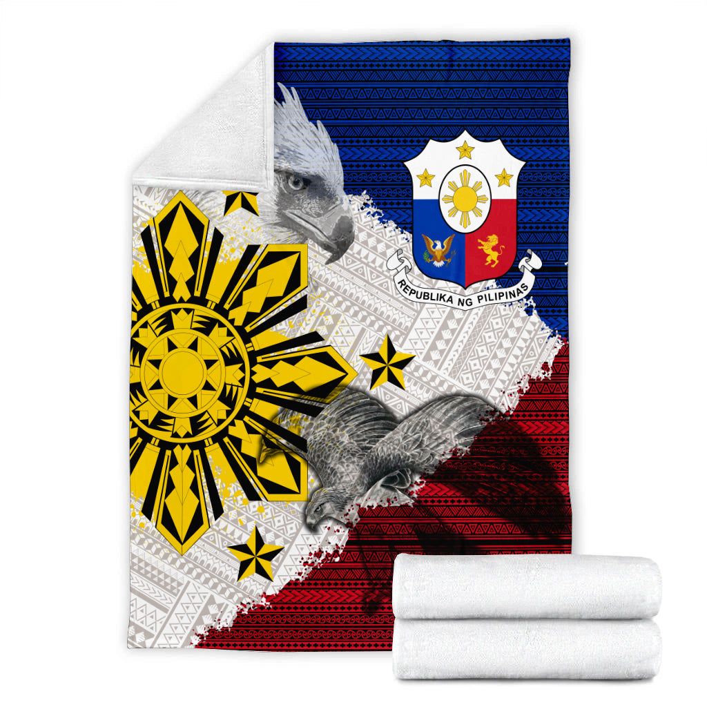 Philippines eagle blanket with blue and red tribal design, rolled white towels in view
