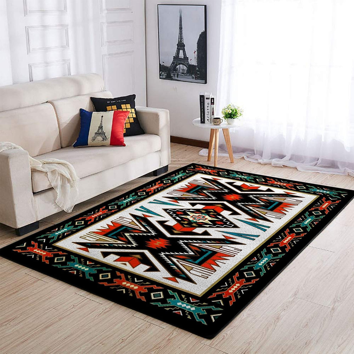 Tribal geometric area rug with black border and colorful red, teal, and cream patterns