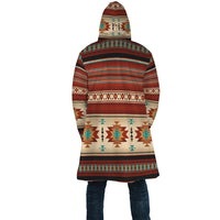 Back view of hooded cloak with colorful geometric stripes and diamond motifs