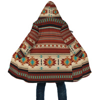 Front view close-up: hooded cloak with colorful geometric stripe and diamond pattern