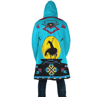 Turquoise unisex cloak back view with large horse-on-circle graphic and geometric pattern hem