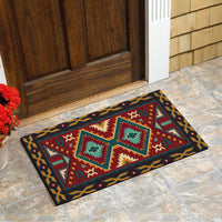 Multicolor geometric doormat on stone floor, teal red yellow diamond and star patterns