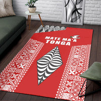 Red rug with 'MATE MA'A TONGA' text and white/black Polynesian border