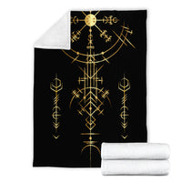 Black blanket set with two rolled white fleece blankets; gold rune print visible