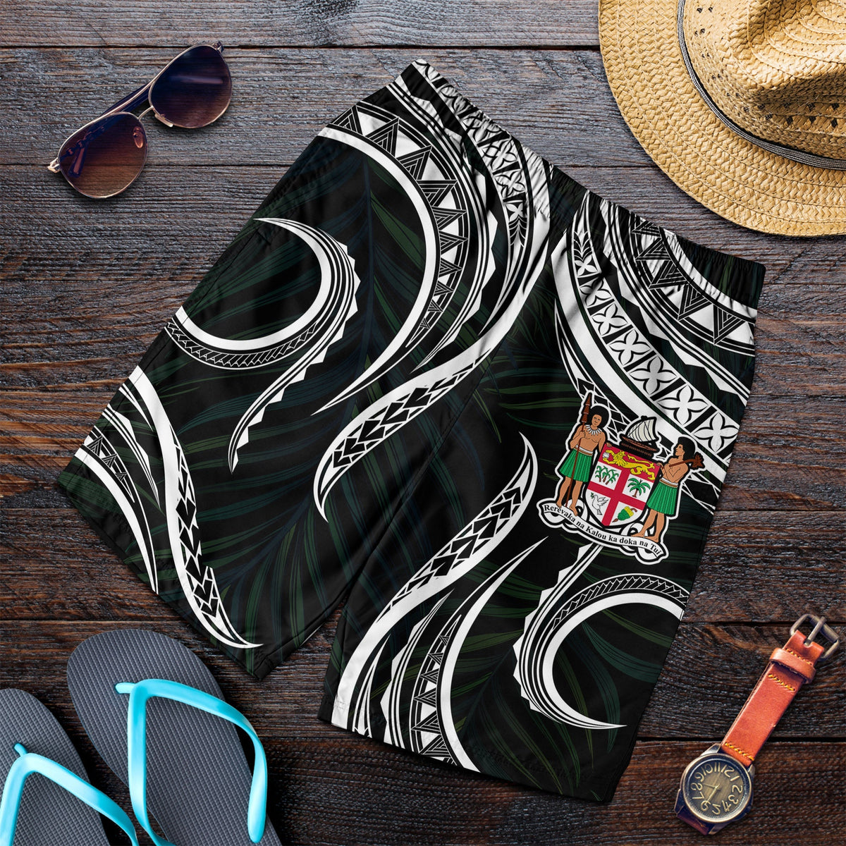 Men’s shorts with Fiji coat of arms on black fabric, white Polynesian wave and circle motifs