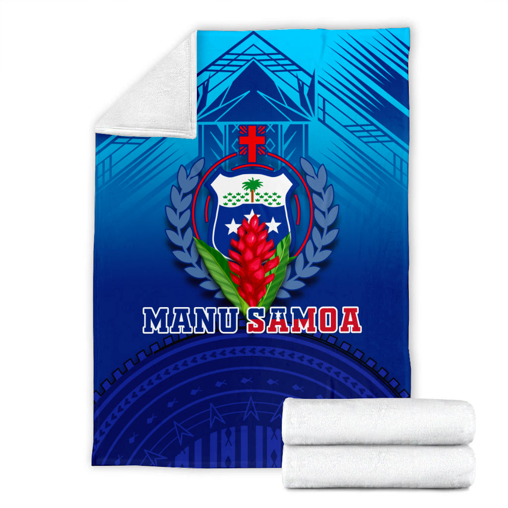 Blue Manu Samoa blanket with shield crest; folded with two rolled white towels