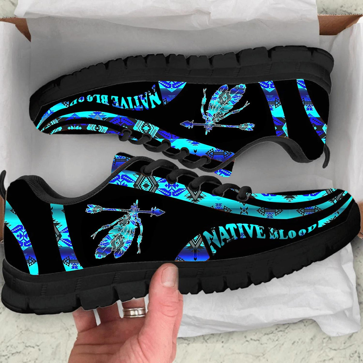 Black sole sneaker with blue Native American feather pattern, lace-up