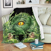 Premium blanket with dinosaur eye and green fern design on dark fabric