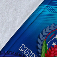 Close-up of blue Manu Samoa blanket fabric edge with partial wordmark and laurel detail