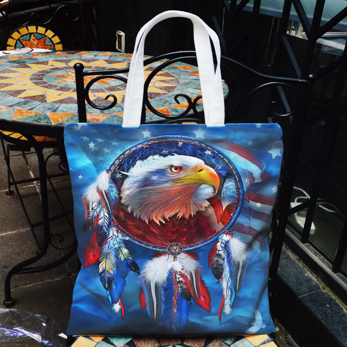Canvas tote bag with eagle dreamcatcher graphic, blue multicolor feather print, white handles