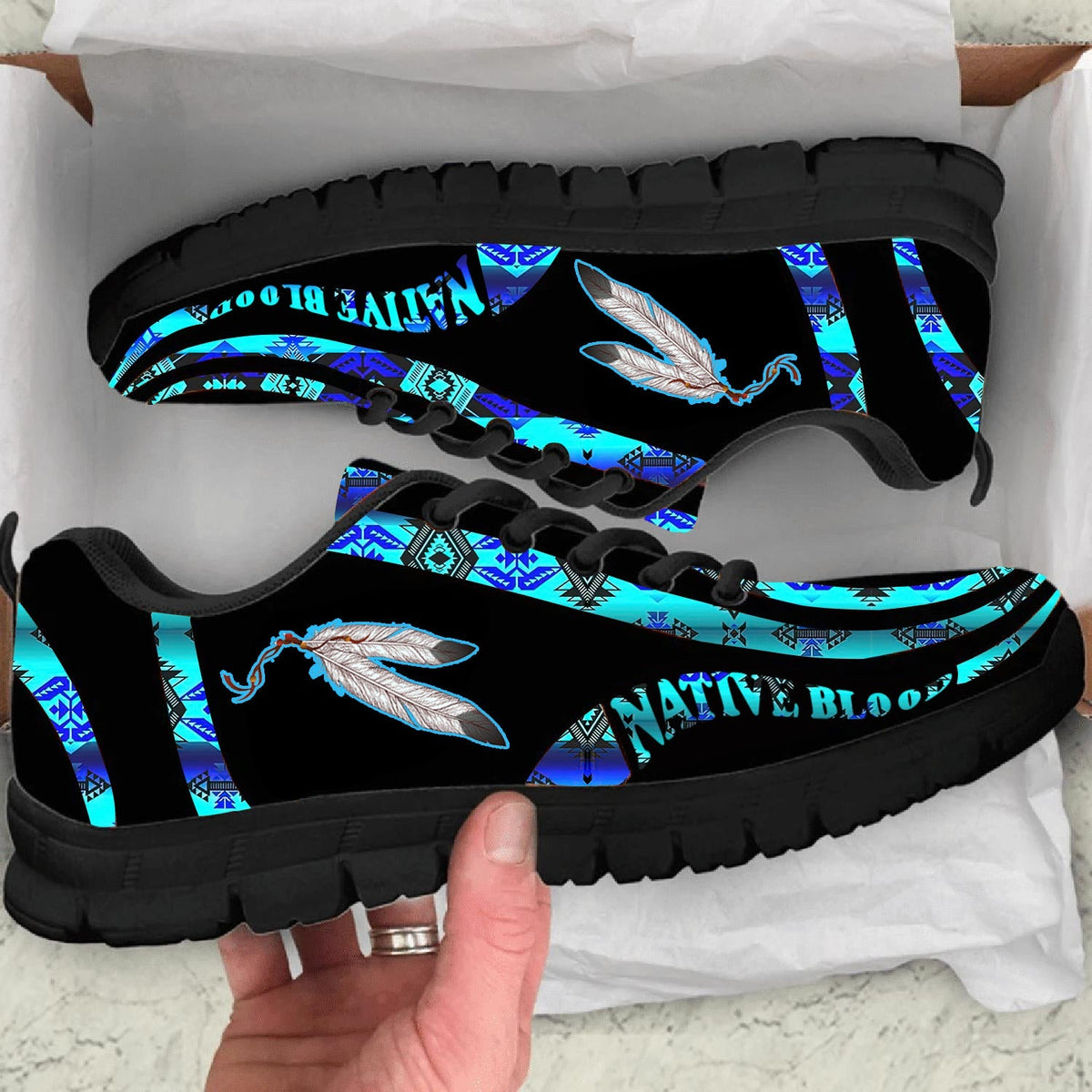 Black sneakers with blue feather and tribal print, black sole, lace-up front