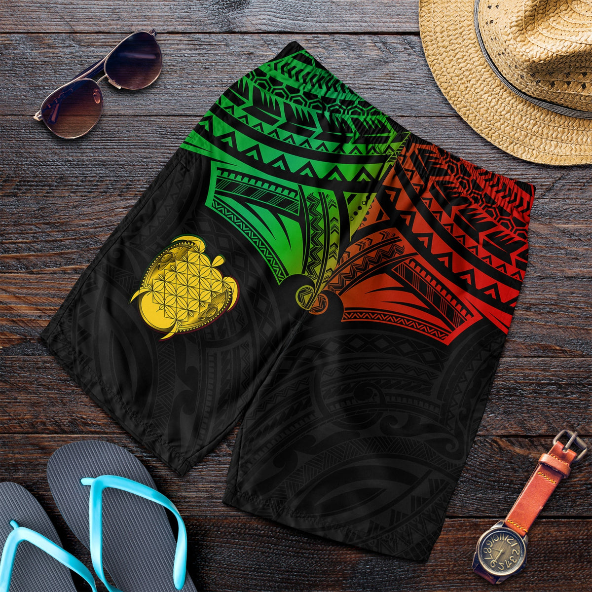 Men’s tropical swim shorts, black with green and red tribal pattern and gold heart turtle
