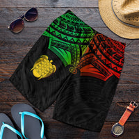 Men’s tropical swim shorts, black with green and red tribal pattern and gold heart turtle