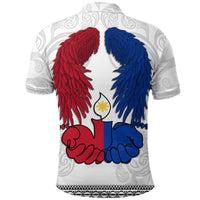 White polo shirt, back print of red and blue wings with All Saints Day graphic.