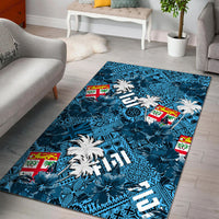 Teal-blue tropical rug with palm trees, hibiscus-like blooms, and geometric patterns