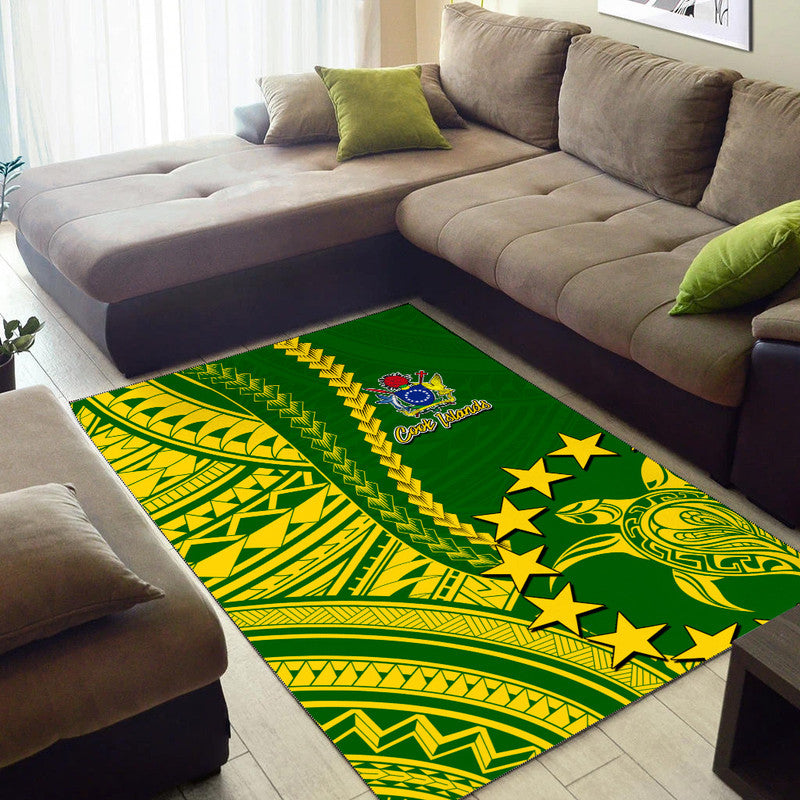 Green area rug with bold yellow Polynesian-style stripes, stars, and crest emblem
