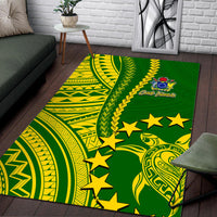 Green Polynesian area rug with yellow curves, geometric designs, and star accents