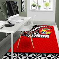 Red rectangular Tonga area rug with crest, tribal tattoo graphics, and black/white border
