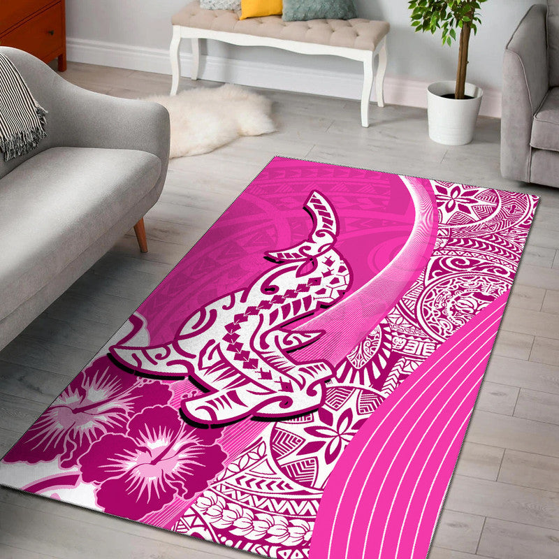 Pink Polynesian-style area rug with shark illustration and floral tribal patterns