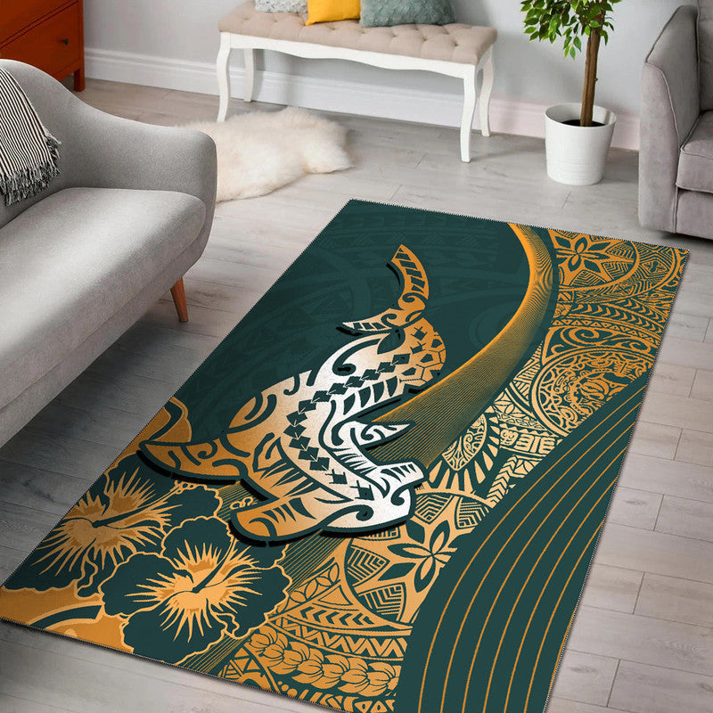 Green Polynesian-style rug with stylized shark, flowers, and ornate border.