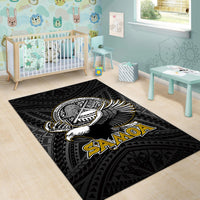 Black rug with winged bird crest and 'SAMOA' text, geometric tribal pattern