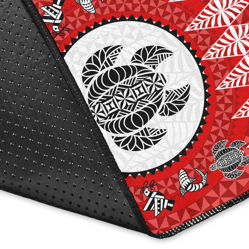 Corner close-up of red Tonga rug with white oval emblem and black edge trim