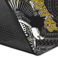 Close-up of black rug edge with winged bird graphic, 'SAMOA' letters and stitching