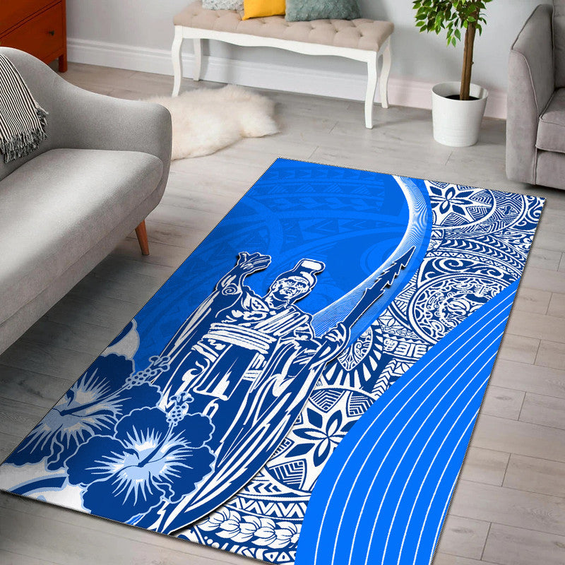 Blue area rug with white Hawaiian floral and Kamehameha-style portrait graphic