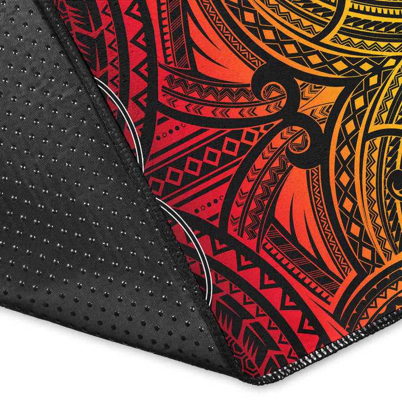 Corner close-up of red and black rugby area rug with yellow tribal print and stitching