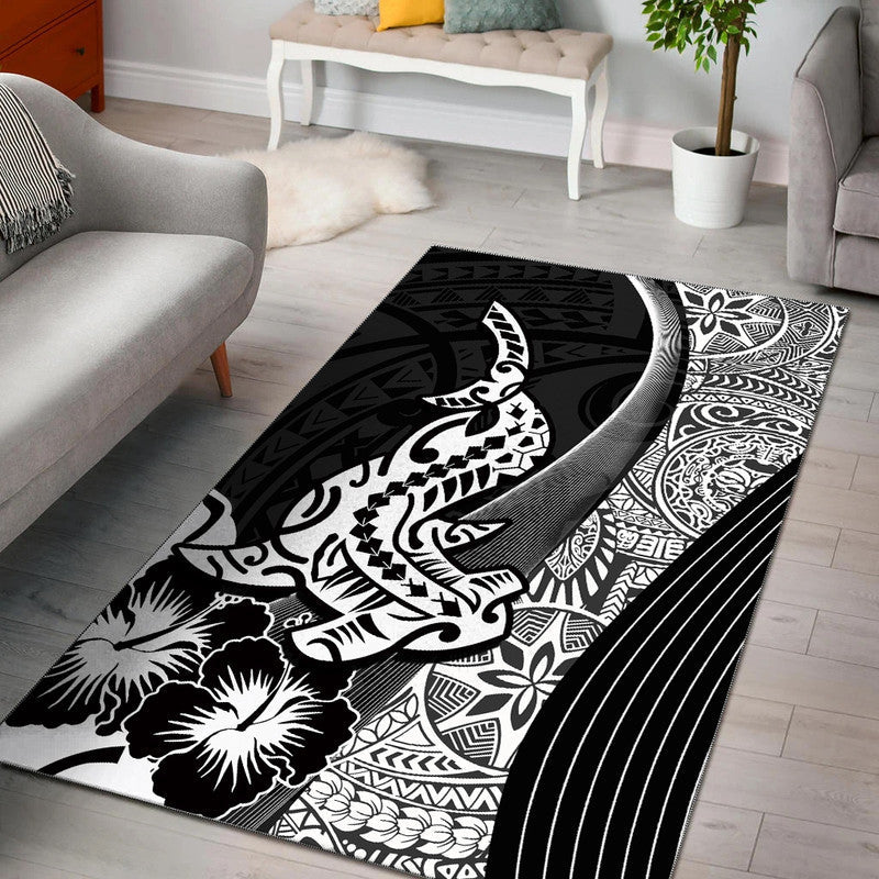 Black rug with white tribal shark, floral and geometric Polynesian motifs.