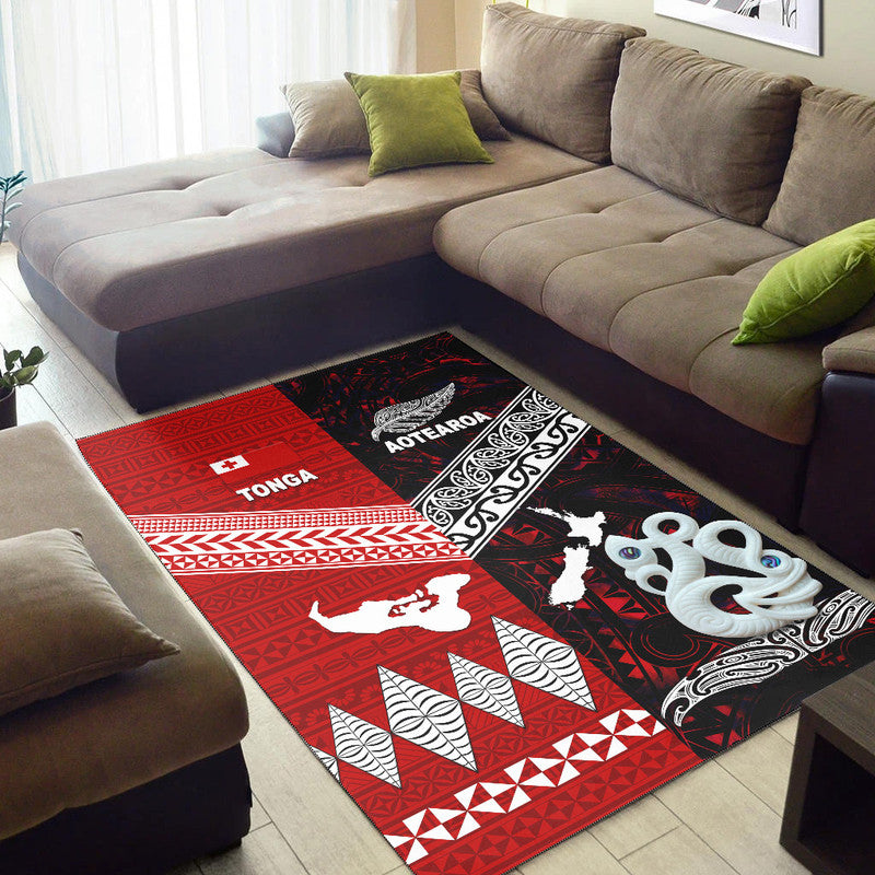 Red and black rug with geometric bands, white bird motifs, and swirling decorative border