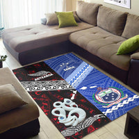 Corner view of red-and-blue Aotearoa & Samoa area rug with tribal motifs and icons