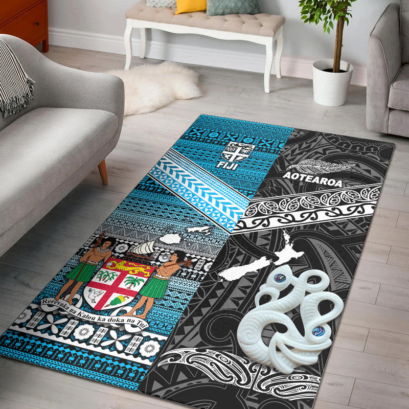 Black area rug with blue tribal patterns, white motifs, and AOTEAROA/FIJI graphics