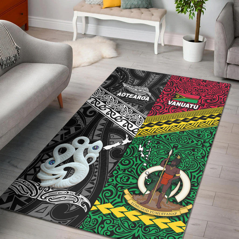 Black area rug with Polynesian map graphics in white, red, and green