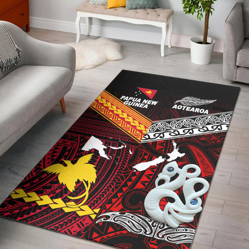 Red and black area rug with Aotearoa and Papua New Guinea tribal graphics