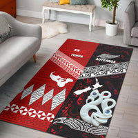 Red and black area rug with tribal patterns, white animal silhouettes, and geometric borders