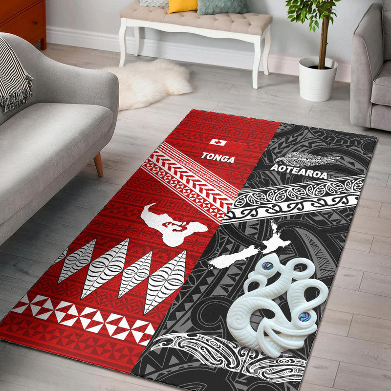 Black area rug with red TONGA panel, AOTEAROA black panel, white motifs