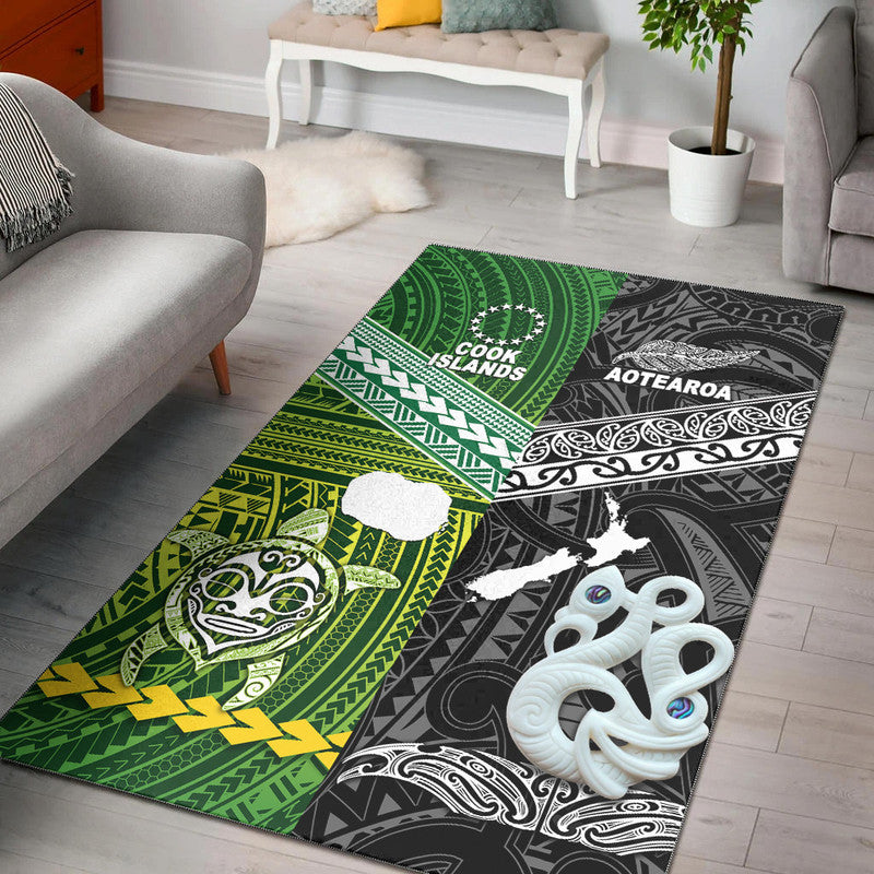 Black area rug with green patterned panels and white Cook Islands map and motifs