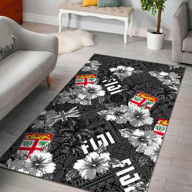 Black area rug with white hibiscus flowers, palm leaves, and island flag squares