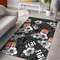 Black area rug with white hibiscus flowers, palm leaves, and island flag squares