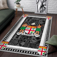Fiji area rug on wood floor, dark charcoal graphic center with white edging