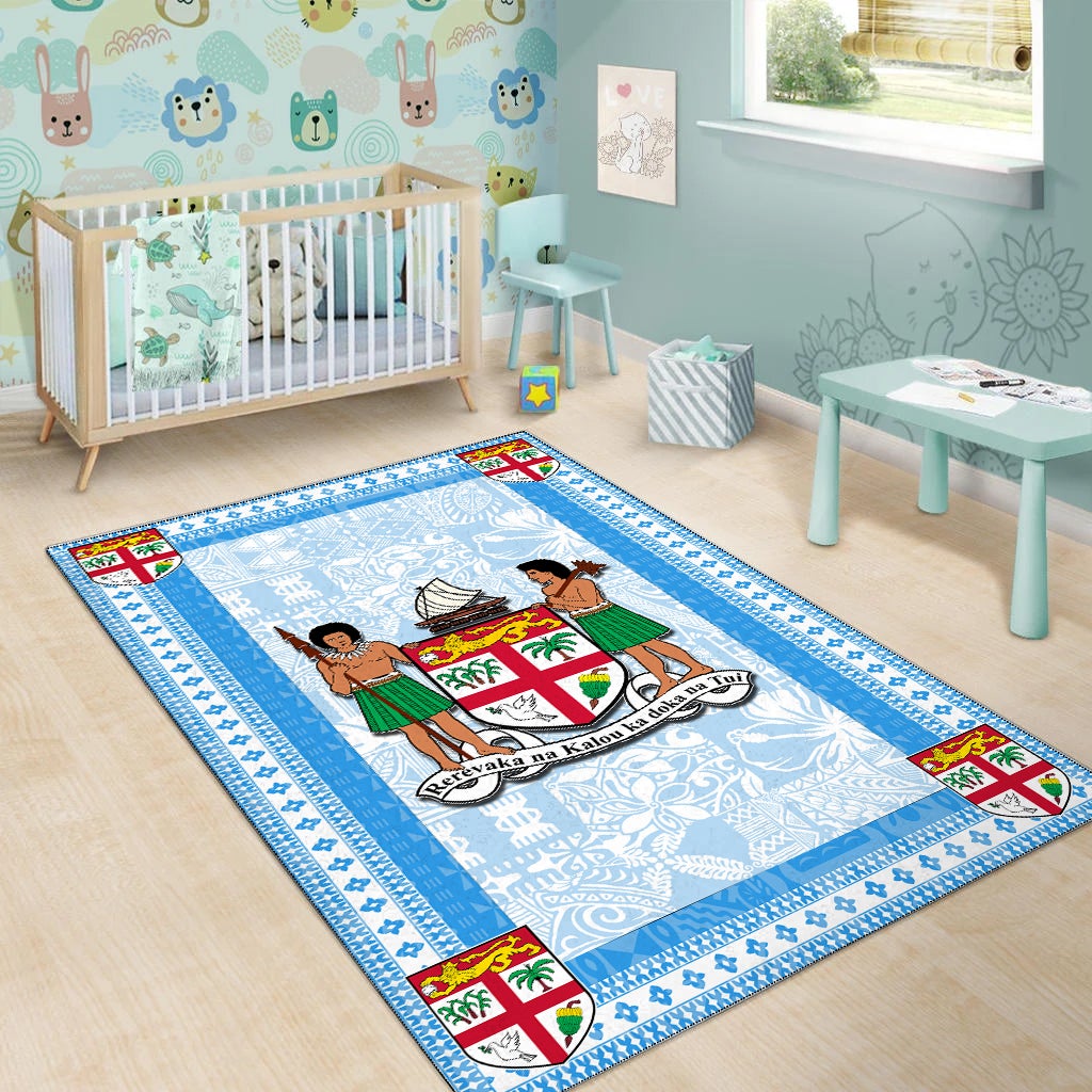 Blue Fiji area rug with crest emblem and border featuring colorful shield accents