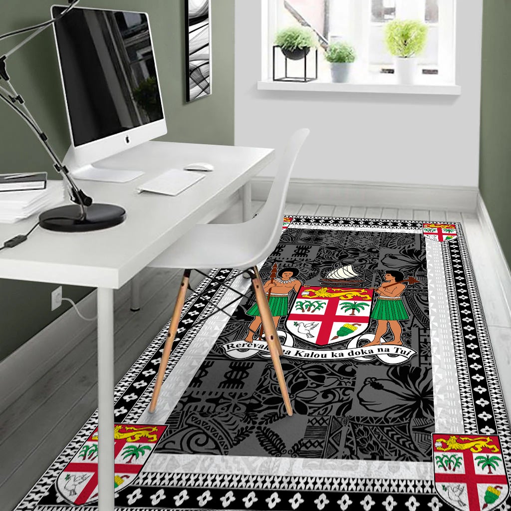 Fiji area rug by desk, dark charcoal design with white border and colorful accents
