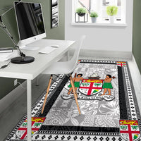 Gray area rug with black geometric border, colorful crest details at the corners