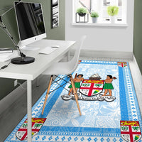 Blue Fiji area rug with crest and island figures, striped blue edge trim