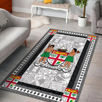 Black-bordered area rug with gray patterned center and colorful island crest motifs