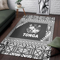 Black Tonga rug with white botanical and geometric border framing central crest