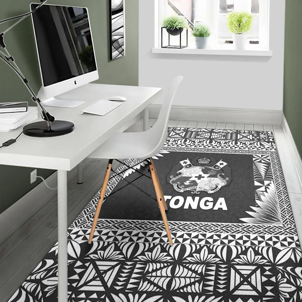 Black Tonga floor rug with central crest and geometric border in black and white