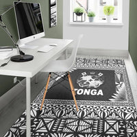 Black Tonga floor rug with central crest and geometric border in black and white